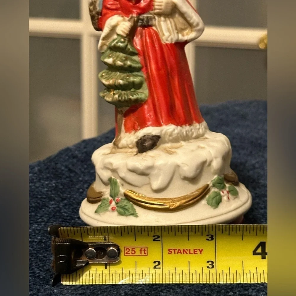 Revolving porcelain Santa musical figure plays Santa Claus is Coming to Town.